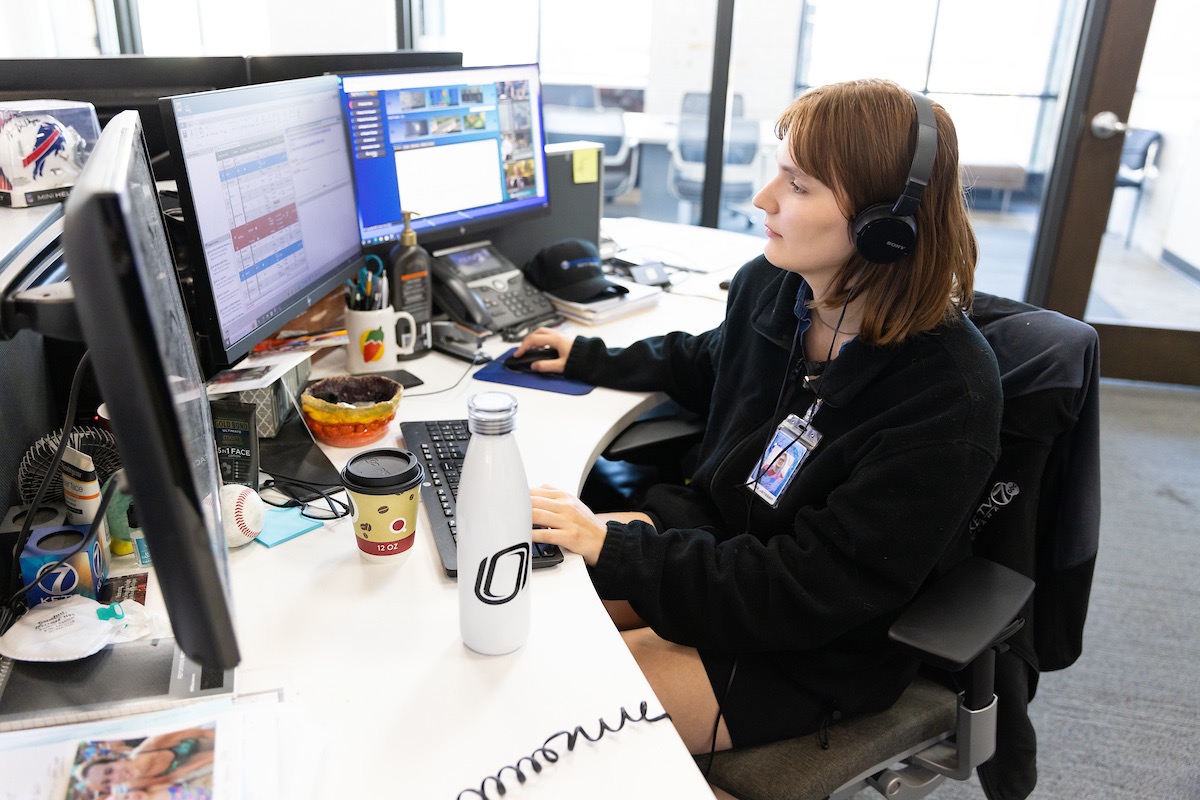 Jenna Janssen hard at work in front of her desk and computer. 