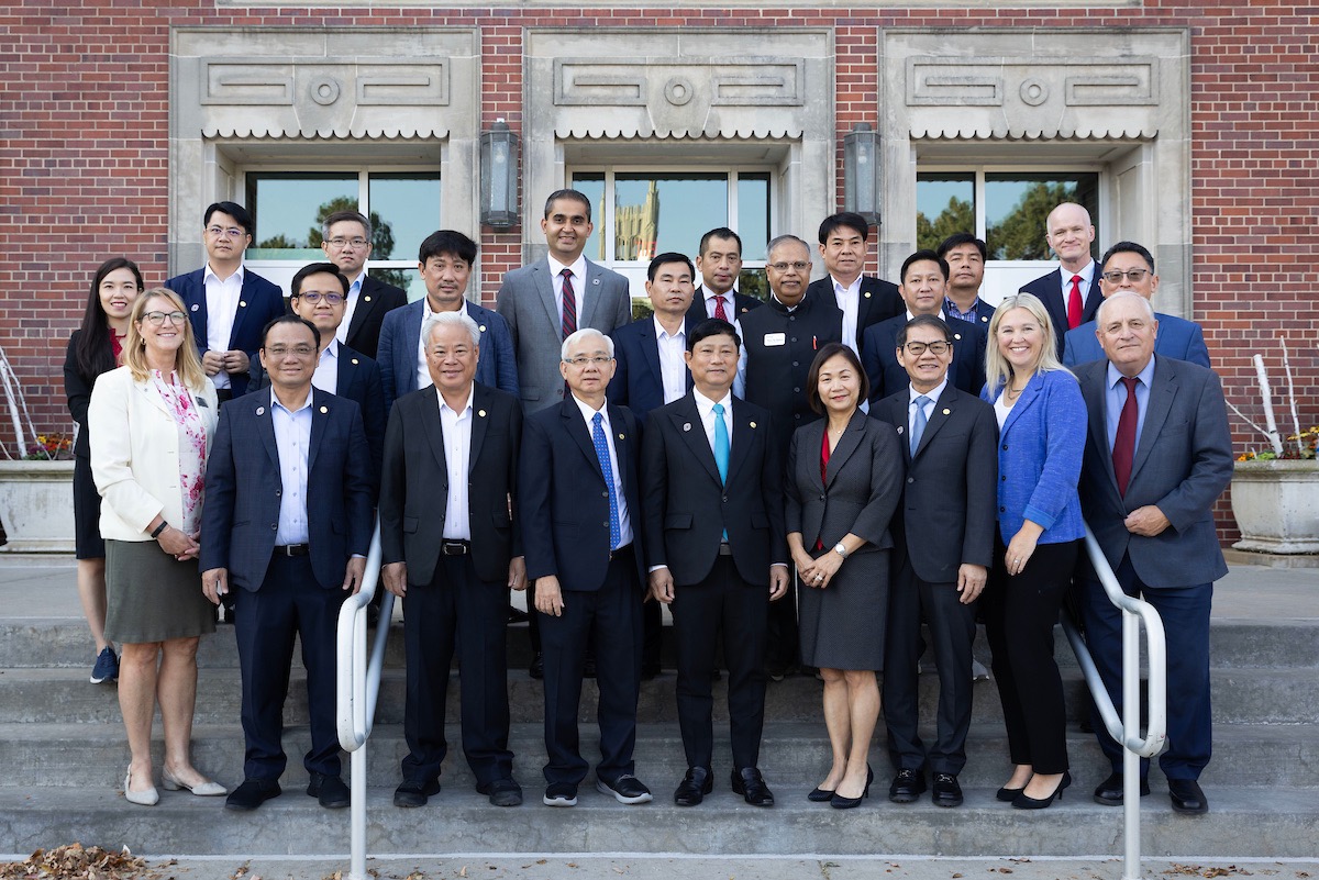 The full delegation poses for a photo with representatives from UNO, led by UNO Chancellor Joanne Li, Ph.D., CFA, outside of the Eppley Administration Building on UNO's campus.