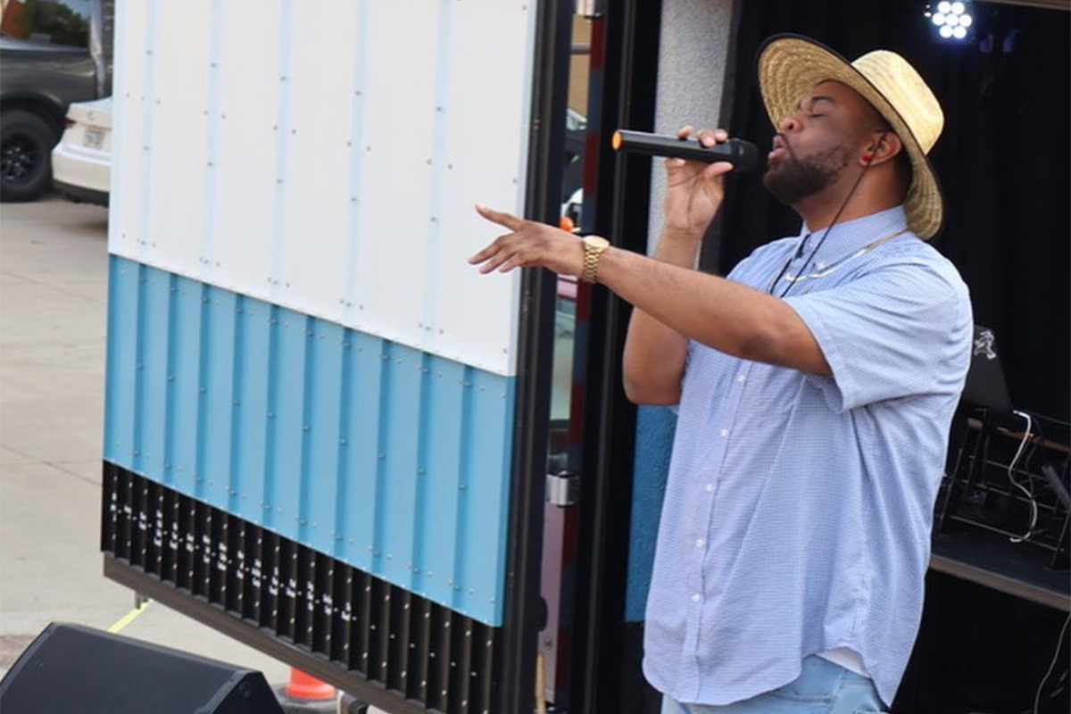 Jus.B performing at a Pull Up and Vibe event along N. 24th Street in Omaha during the summer of 2023.