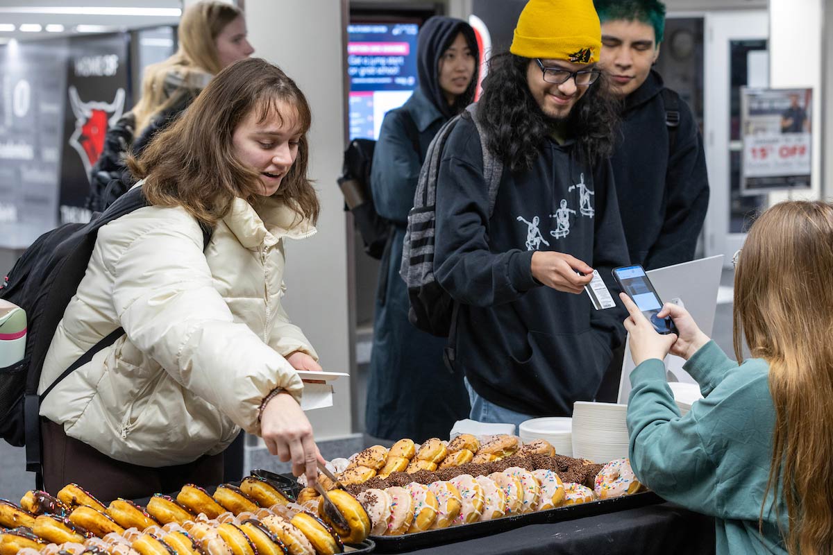 Students picking from a variety of donuts