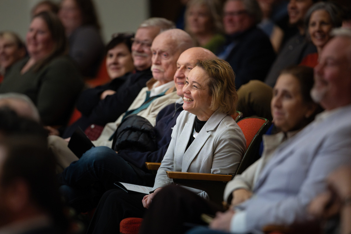 Audience members smilling