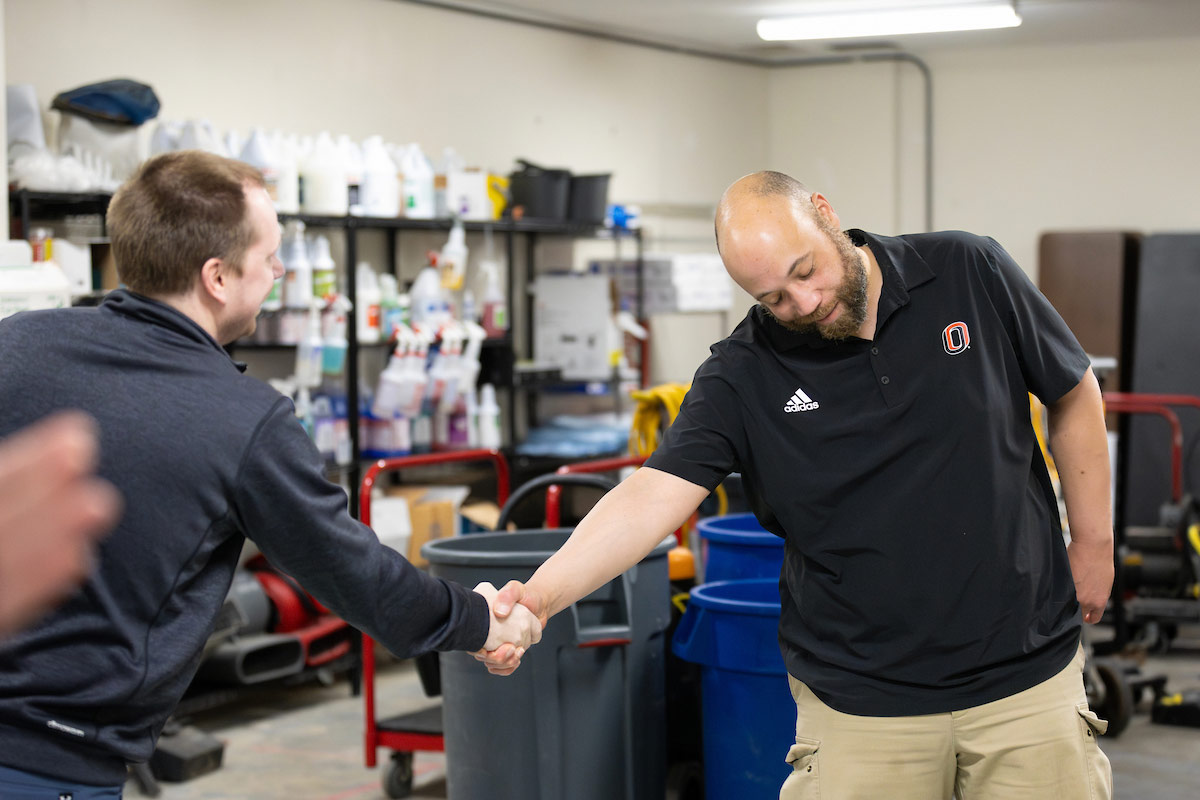 Cornell shaking someone's hand as he receives the award