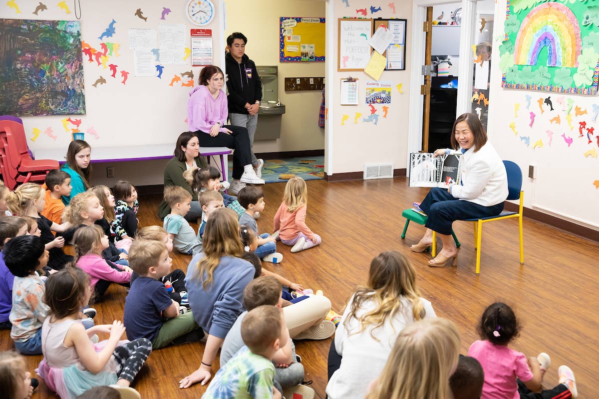UNO Chancellor Joanne Li, Ph.D., CFA, reads to students at the UNO Child Care Center.