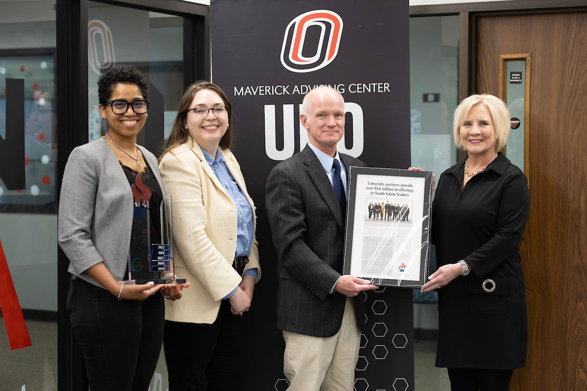 Rashonda Austin, director of Undergraduate Admissions; Maddie Pooley, assistant director of Undergraduate Admissions; and Rich Klein, Ph.D., vice chancellor of Institutional Effectiveness and Student Success, receive the Youth Salute Award from Debbie Brown.
