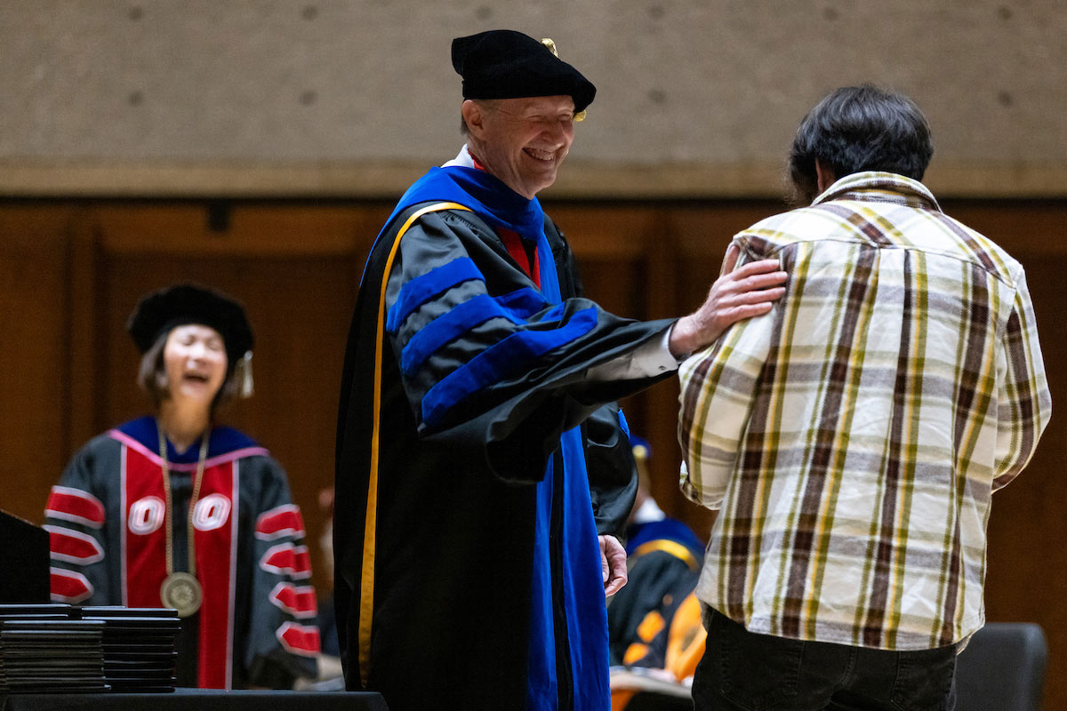 CEHHS Dean Neal Grandgenett, Ph.D., congratulates a student.