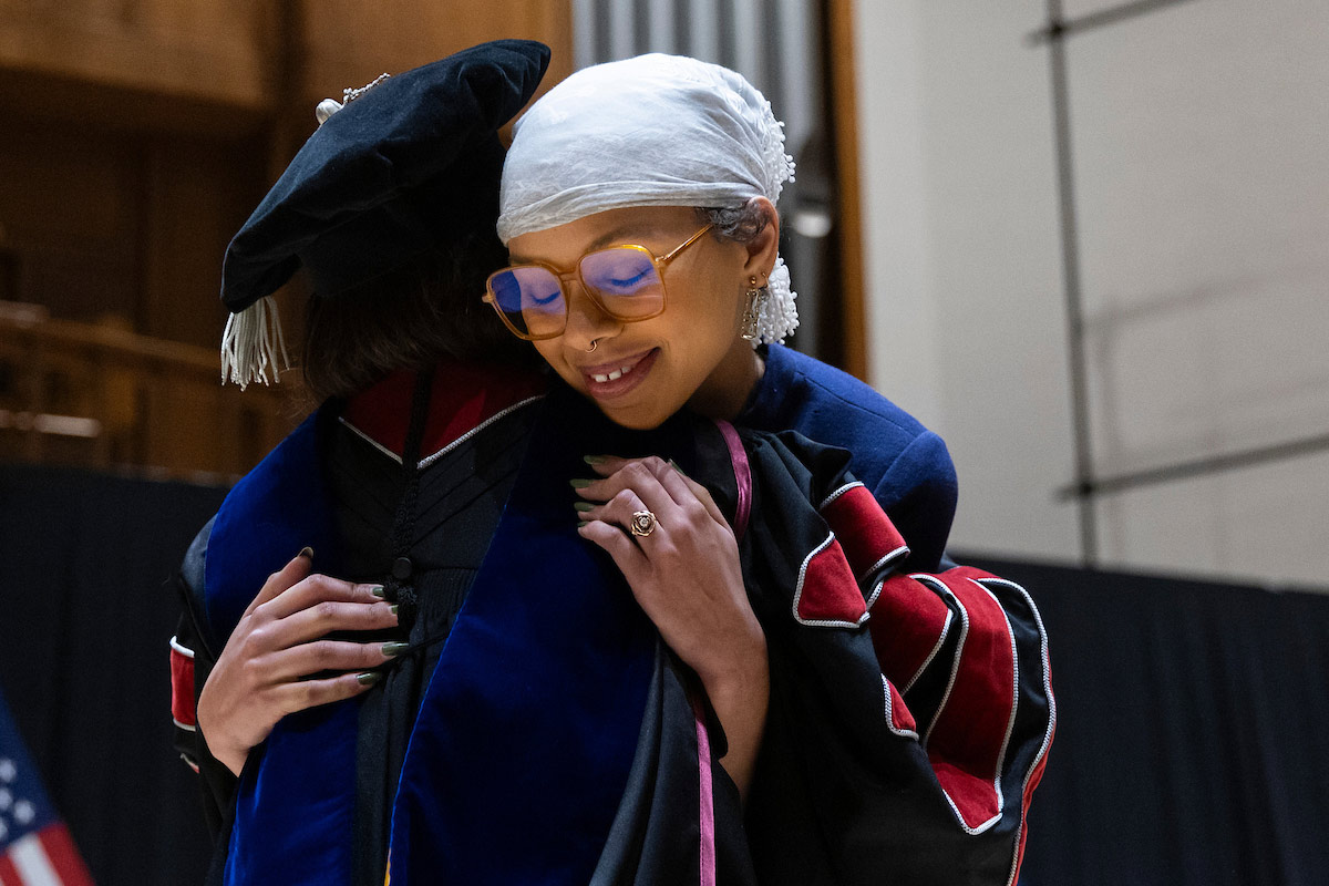 A student hugs Chancellor Joanne Li, Ph.D., CFA