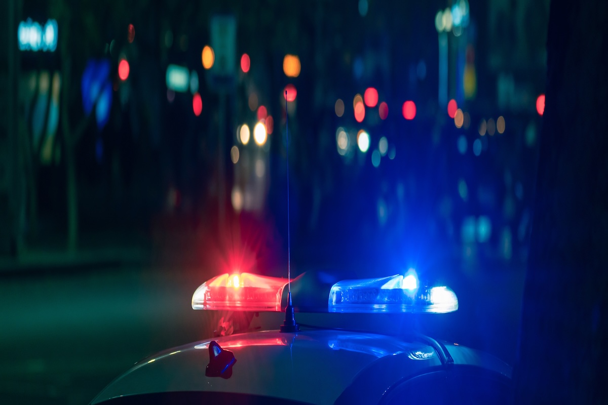 Red and blue lights of a police car close up in the evening, stock photo