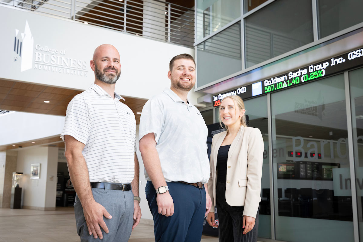 Three of the four students that participated in the capstone project pose together in UNO's College of Business Administration.