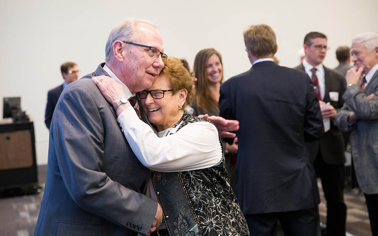 Christensen hugs a colleague at the CPACS Alumni Awards where he received the Hubert Locke Award.