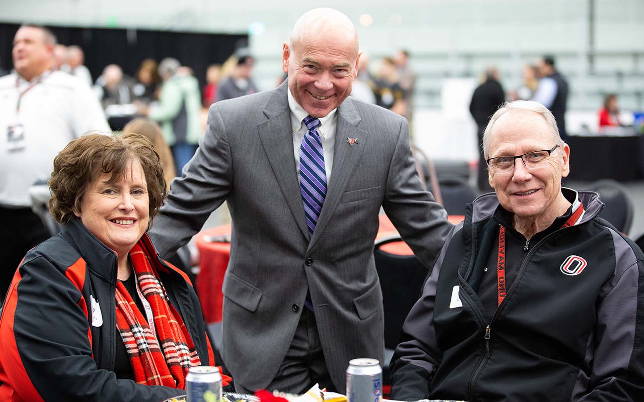 Special Advisor to the Director of Athletics Mike Kemp, center, chats with Christensen and his wife Jan during the President's Pregame event with the NU Foundation prior to an Omaha Hockey game.