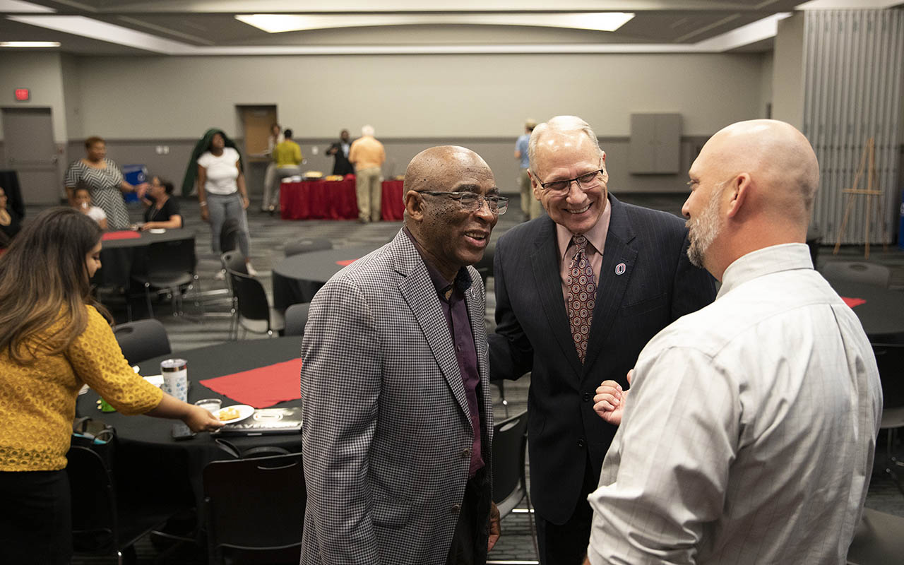 Christensen visiting with James Freeman during his retirement party.
