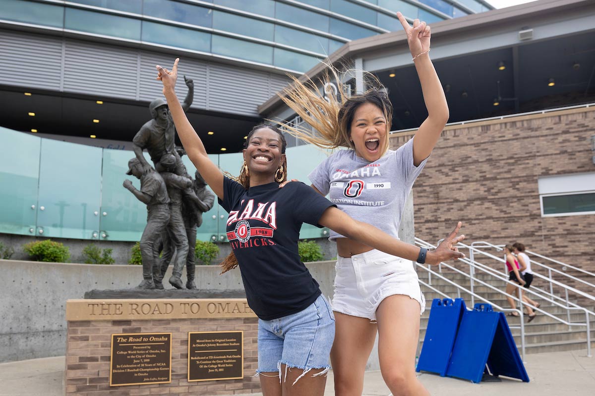 University of Nebraska at Omaha Social Media Ambassadors Miracle Olawuyi, left, and Lana Huetson have their pictures taken during the College World Series