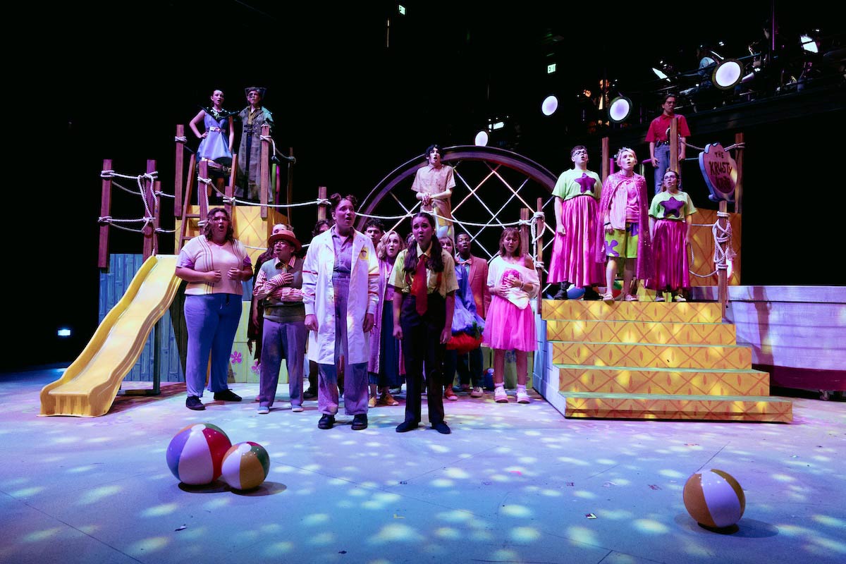 High school students perform a colorful scene from The SpongeBob Musical on stage at UNO’s Black Box Theater.