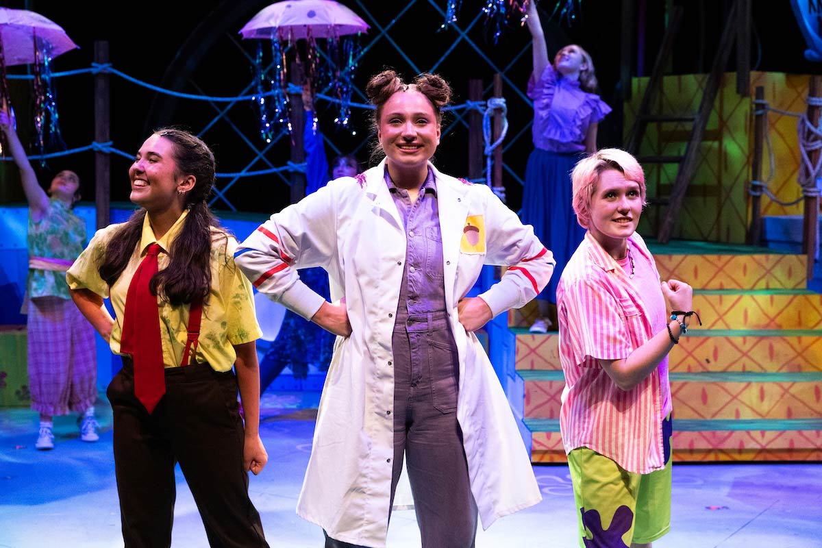 High school students perform a colorful scene from The SpongeBob Musical on stage at UNO’s Black Box Theater.