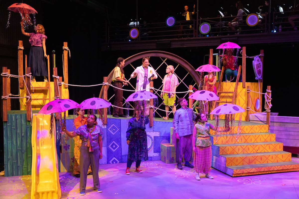 High school students perform a colorful scene from The SpongeBob Musical on stage at UNO’s Black Box Theater.