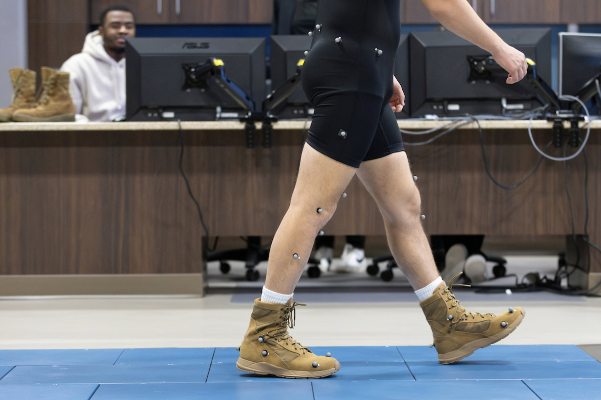 A subject tests a FlyBand® ExoBoot prototype at the University of Nebraska at Omaha Biomechanics Research Building as students observe.  