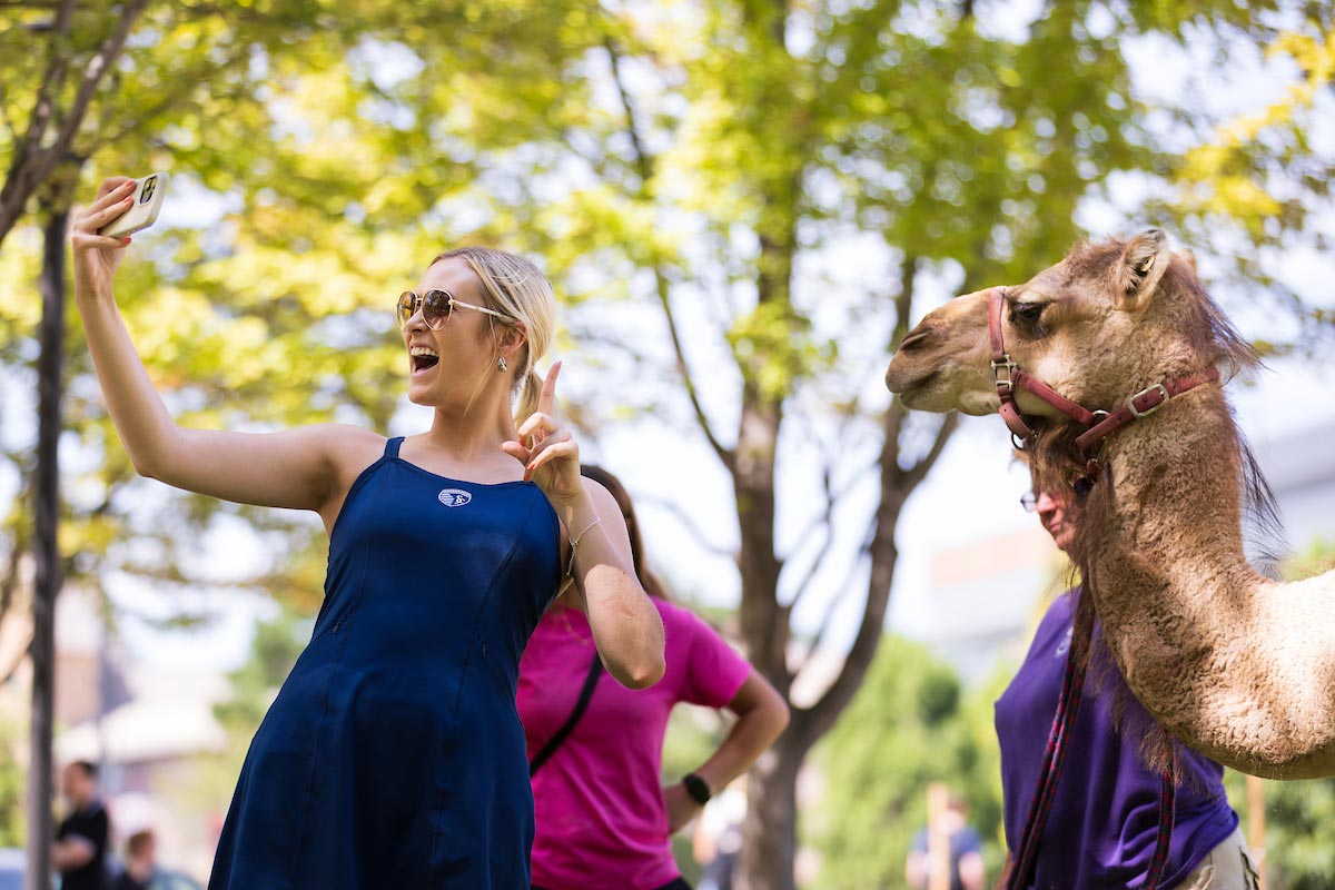 UNO students interact with a camel on Hump Day during Durango Days on Wednesday, August 27, 2025, at the University of Nebraska at Omaha in Omaha, Nebraska.