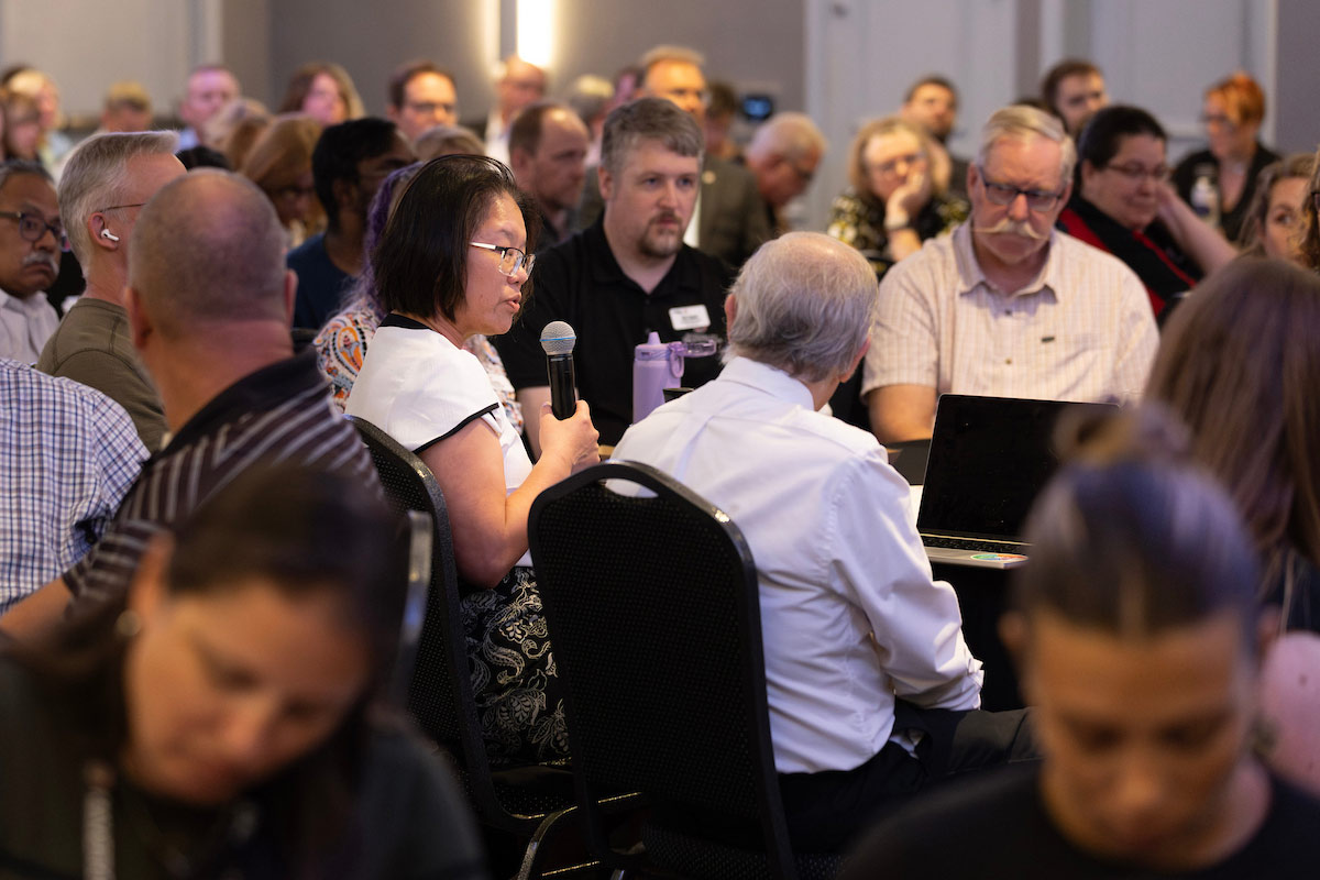 Patty Bick, Ph.D., UNO Faculty Senate President 2024-2025, asks a question during the forum. 