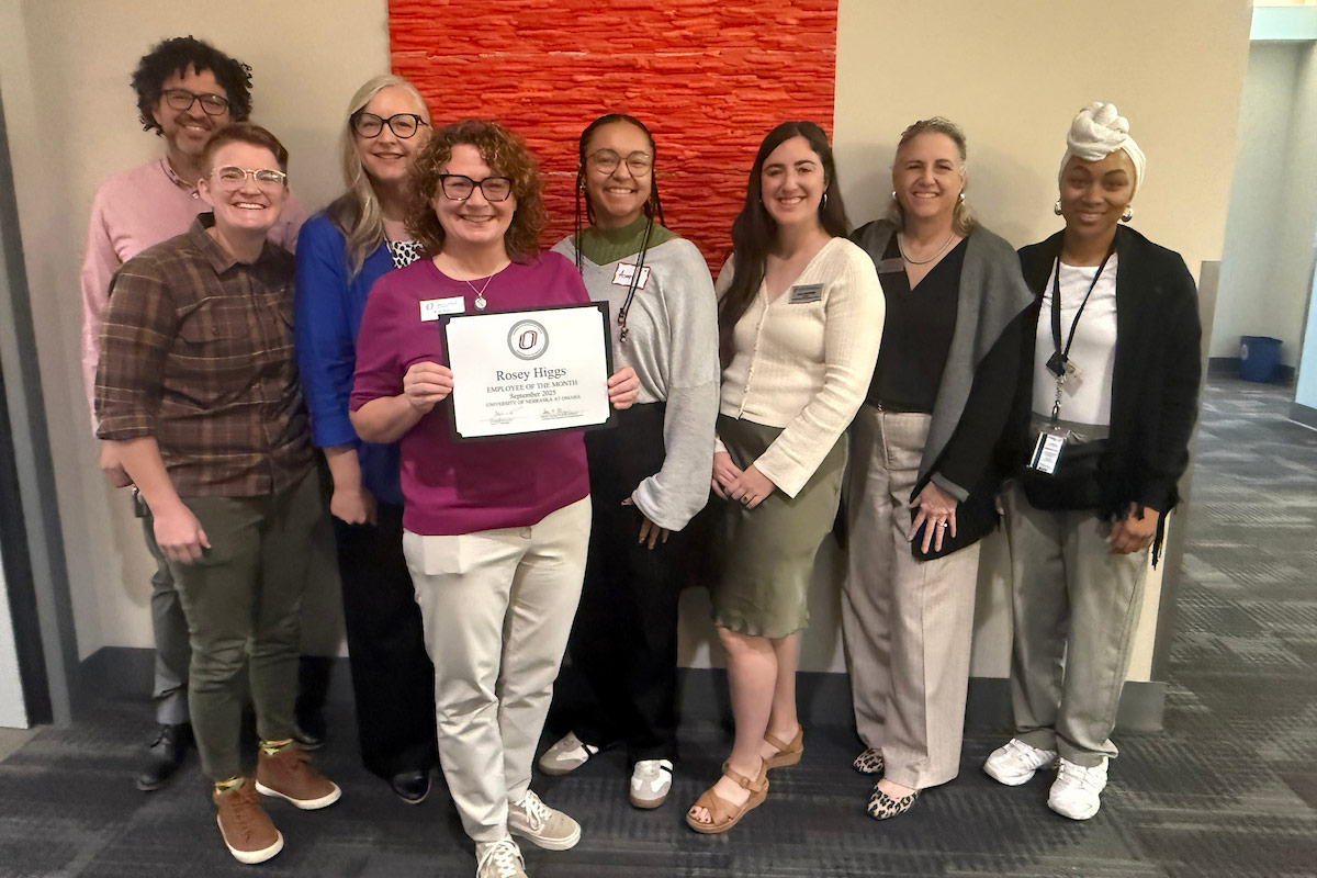 Rosey Higgs (pictured with her certificate) surrounded by her colleagues.
