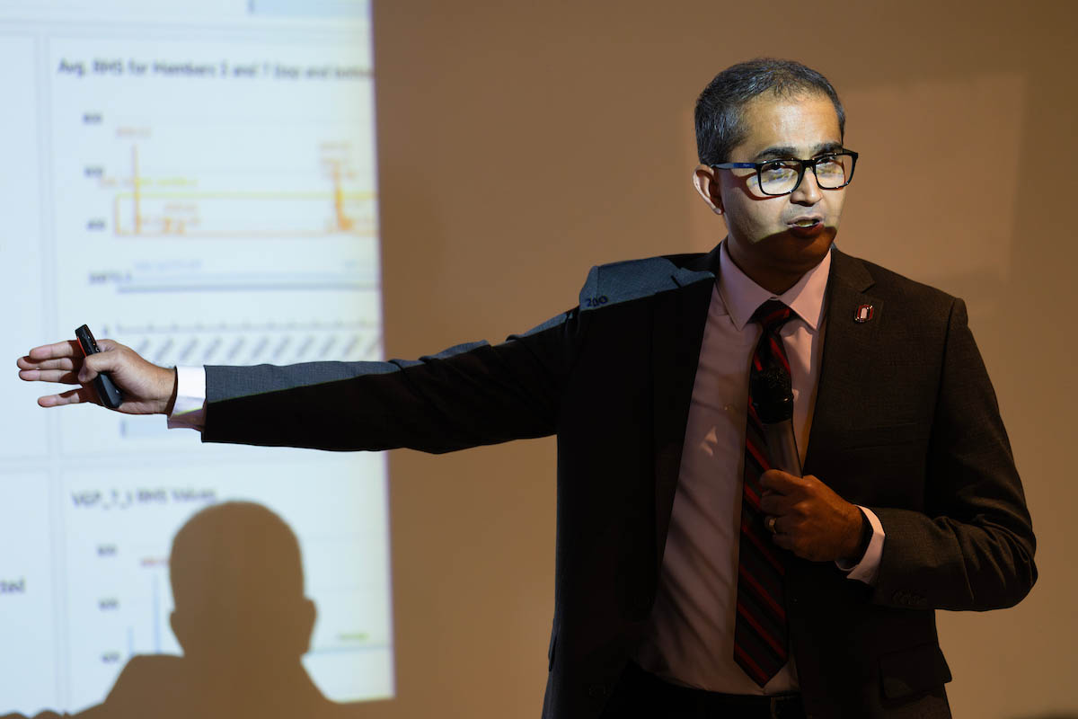 Robin Gandhi, Ph.D., speaks at the podium.