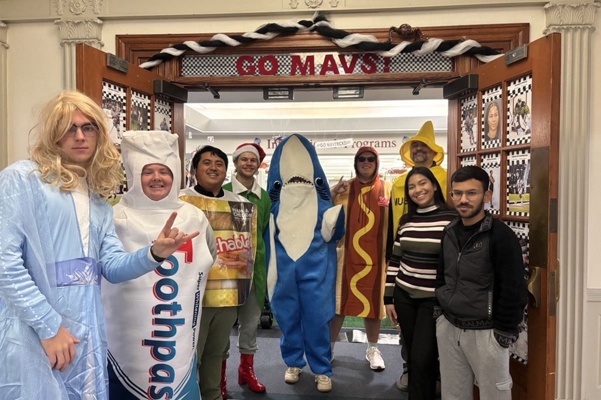 Students in costume participate in the Reverse Trick or Treat food drive.