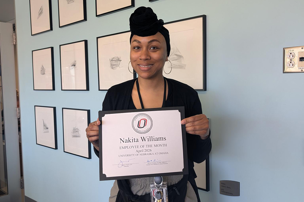 Nakita Williams poses with her Employee of the Month certificate.