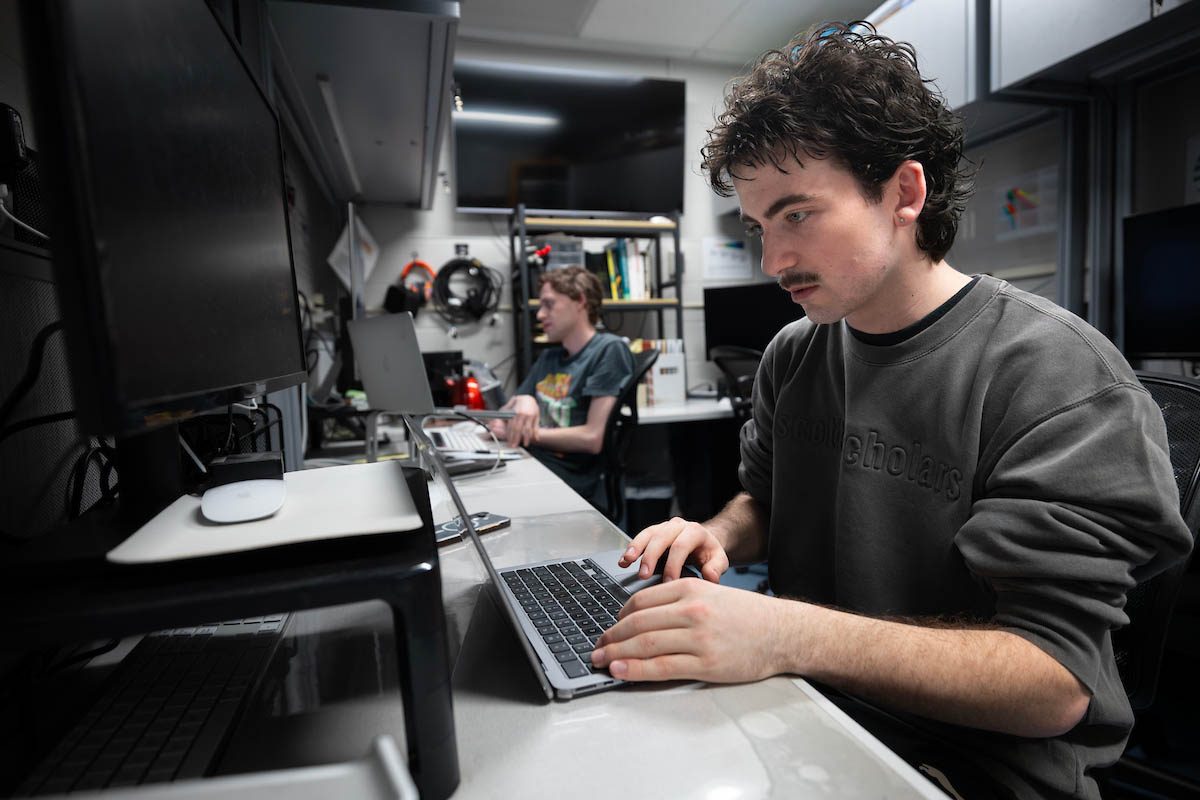 Person working on laptop in office workspace