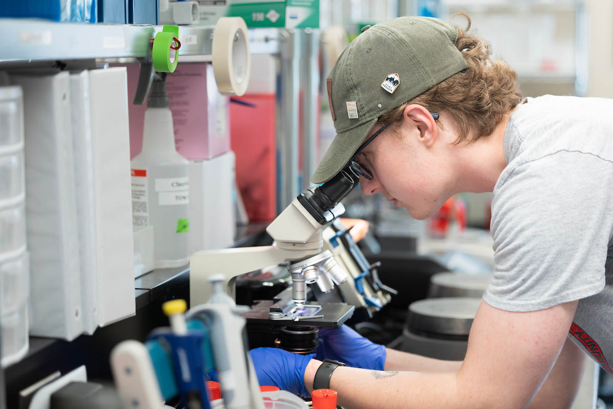 Group portrait of lab team standing together in laboratory