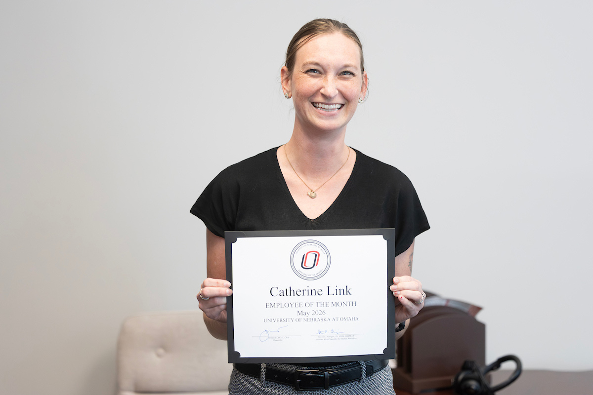 Catherine Link poses with her Employee of the Month certificate.