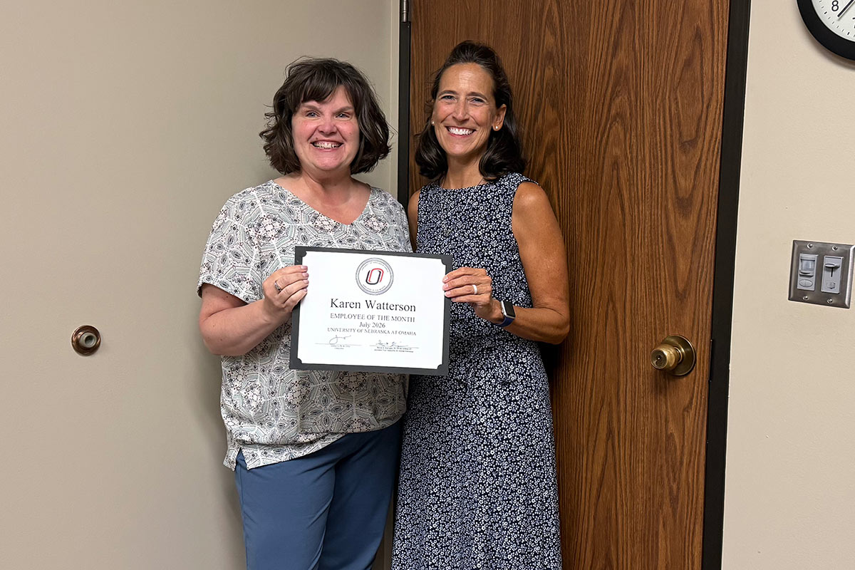 Karen Watterson and Carol Kirchner pose with Karen's Employee of the Month certificate.