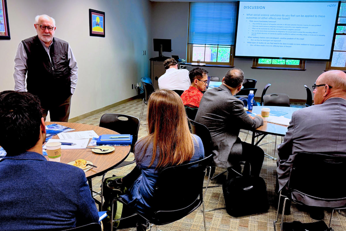Neal Woolen leads a group discussion during a seminar.