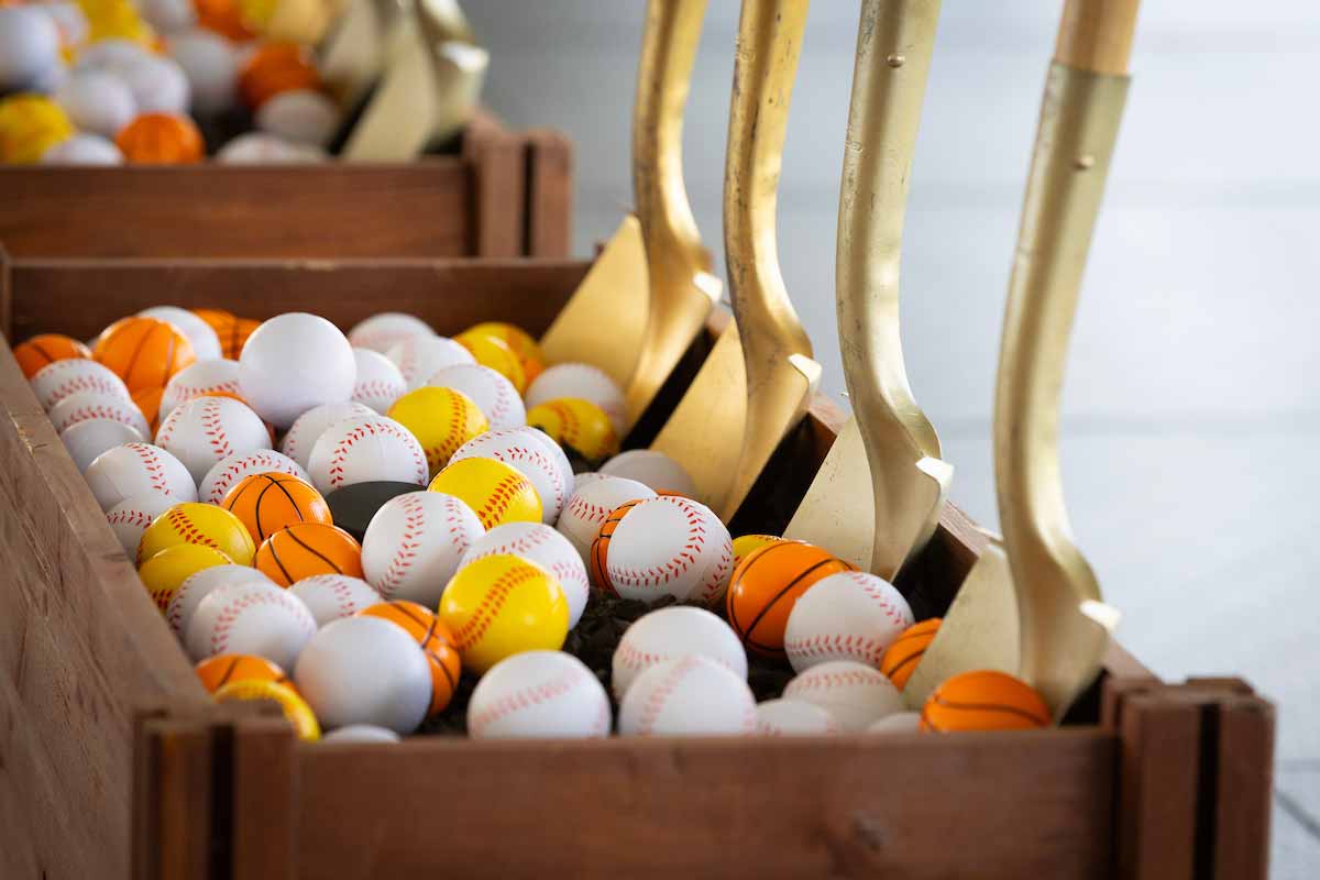 Gold shovels propped upright in a  ceremonial groundbreaking ball bucket. 