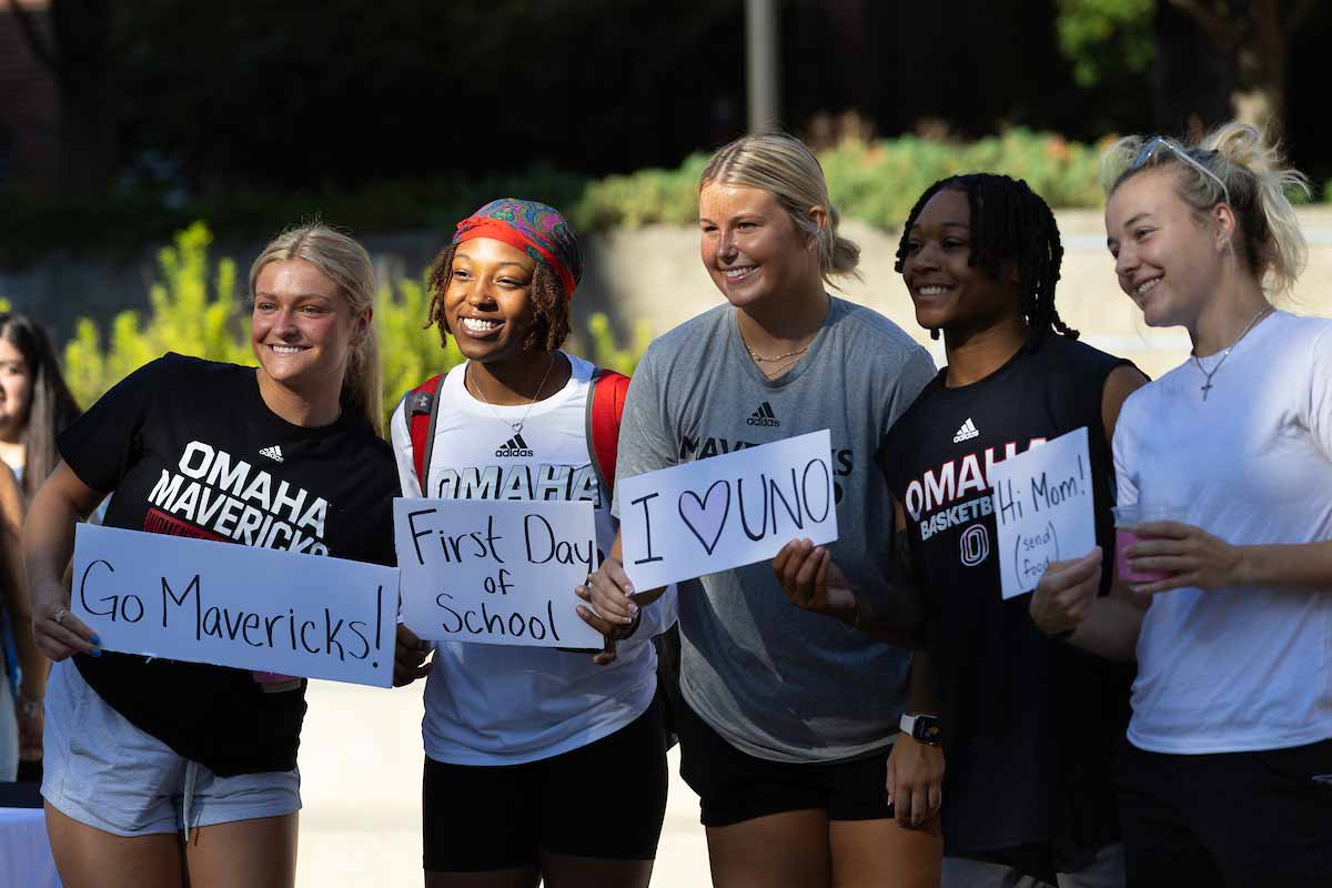Students hold signs on the first day of classes. 