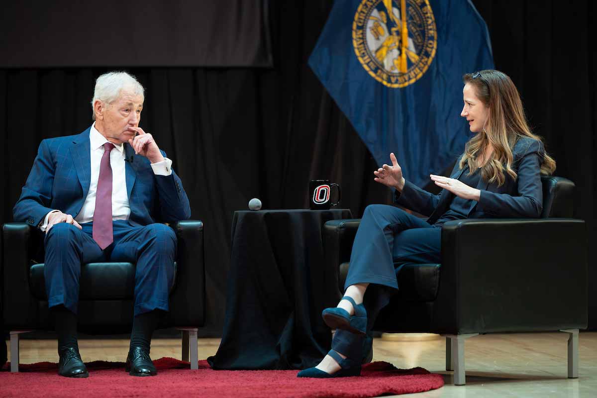 Chuck Hagel and Avril Haines sit on stage in conversation during the Hagel Forum in Global Leadership at the University of Nebraska at Omaha. 