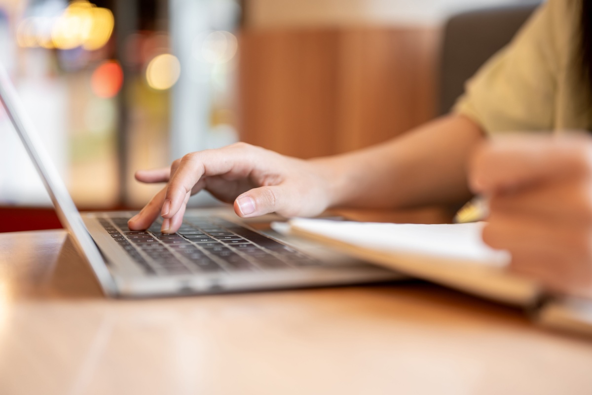 closeup of a person typing on a computer