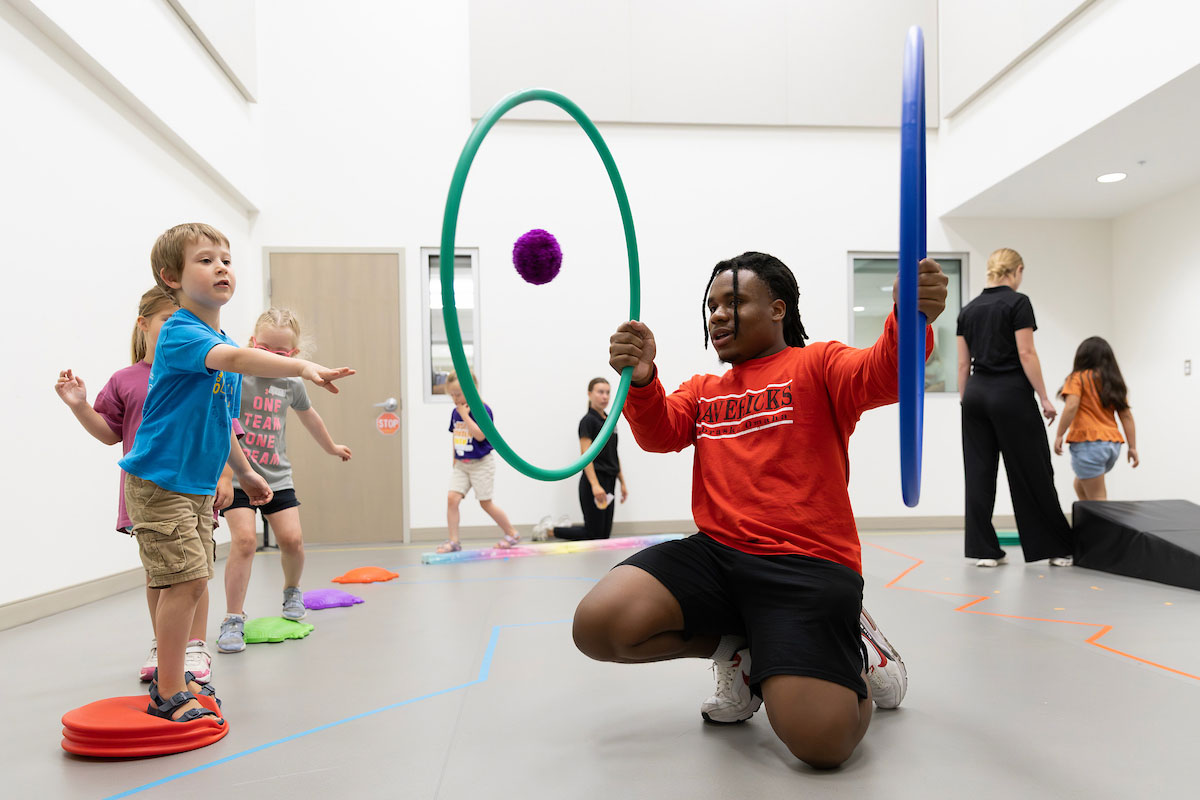 Tydell McLaurin, a kinesiology undergraduate student, works with children at the Young Athletes Program at the Health Science Collaborative (HSC) in the University of Nebraska at Omaha’s School of Health & Kinesiology in Omaha, Nebraska, on June 11, 2026. (Ryan Soderlin/UNO Marketing and Communications)