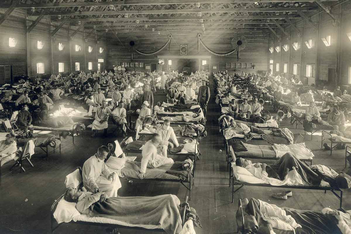 A photo of ill patients lying in beds in an army bunker during the 1918 flu pandemic.