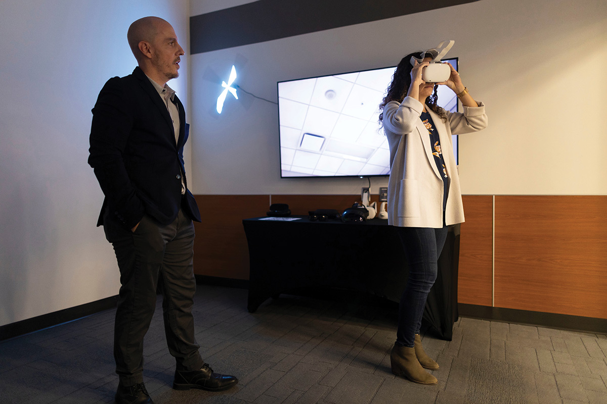 Sam Hunter, NCITE’s Lead of Strategic Operations, left, leads, Christine Abizaid, Director of the National Counterterrorism Center, through a demonstration of virtual reality technology.