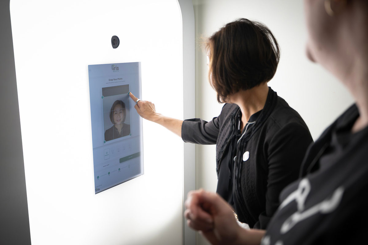 A woman crops a photo of herself taken with the Maverick Headshot Studio