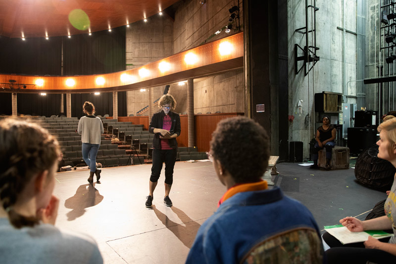 Brown reviews notes with the cast of "All's Well That Ends Well."