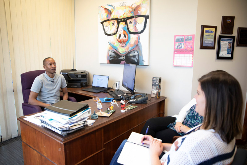 Clark holds meeting in his office.