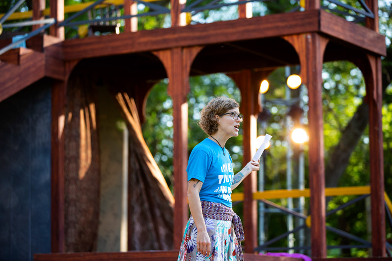 Alumna Sarah Brown speaks during opening night of Nebraska Shakespeare's 2019 "Shakespeare on the Green" season.