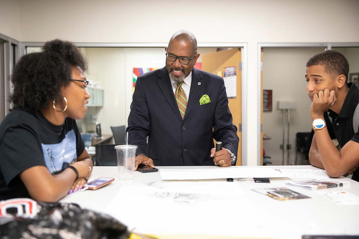 Mentor Omar Correa chats with students during a meeting of the Young Kings in the Office of Multicultural Affairs.
