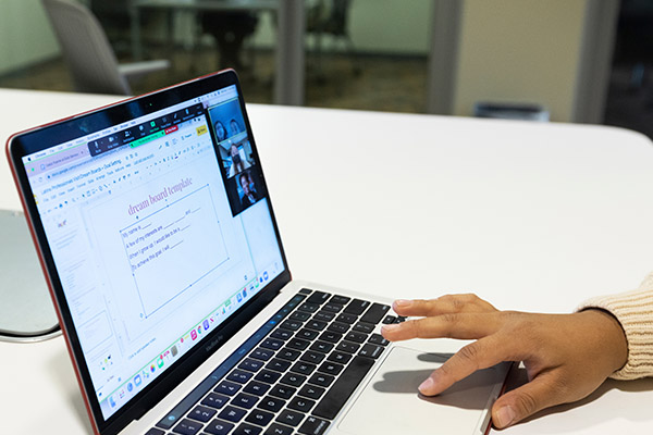 close view of a hand using an open laptop