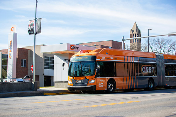 Omaha Orbt bus at bus stop in front of UNO's campus