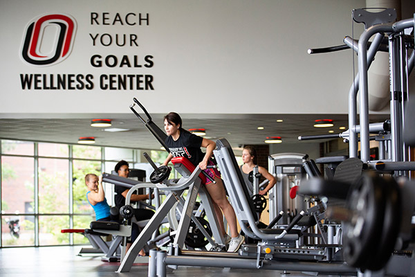 UNO gym full of workout machines with some of them in use
