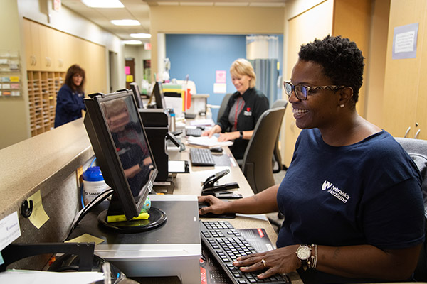 line of receptionists at computers at a large check in desk