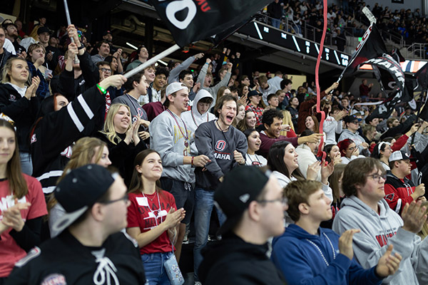 huge crowd of sports fans cheering and celebrating for UNO