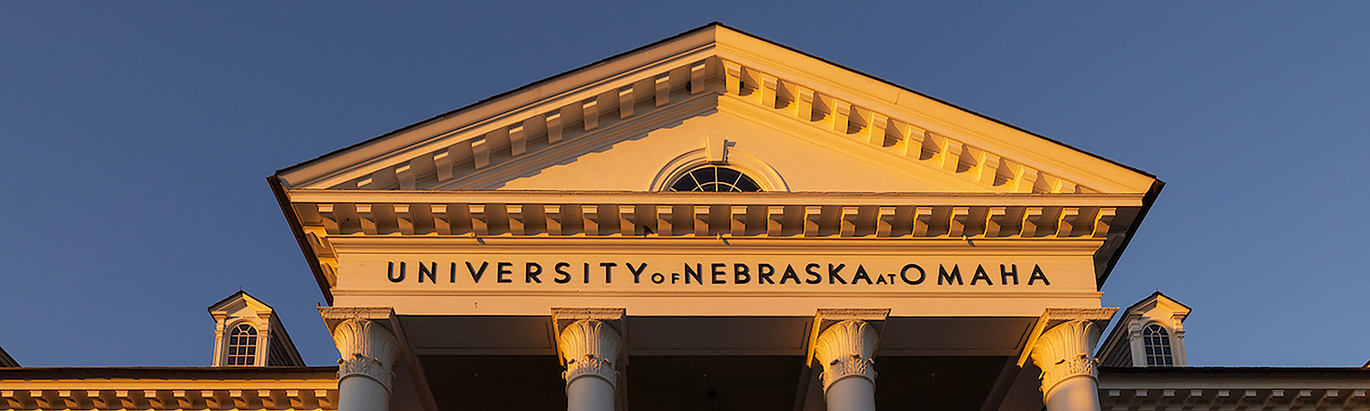 photo of UNO Arts & Sciences building at sunrise