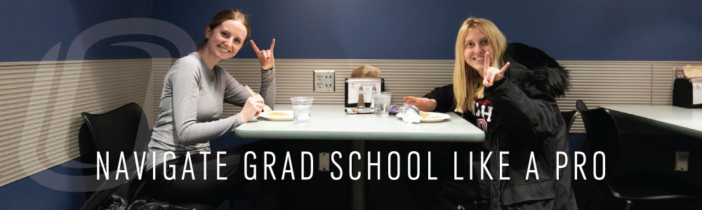 Two female students studying at a table with the words navigate grad school like a pro